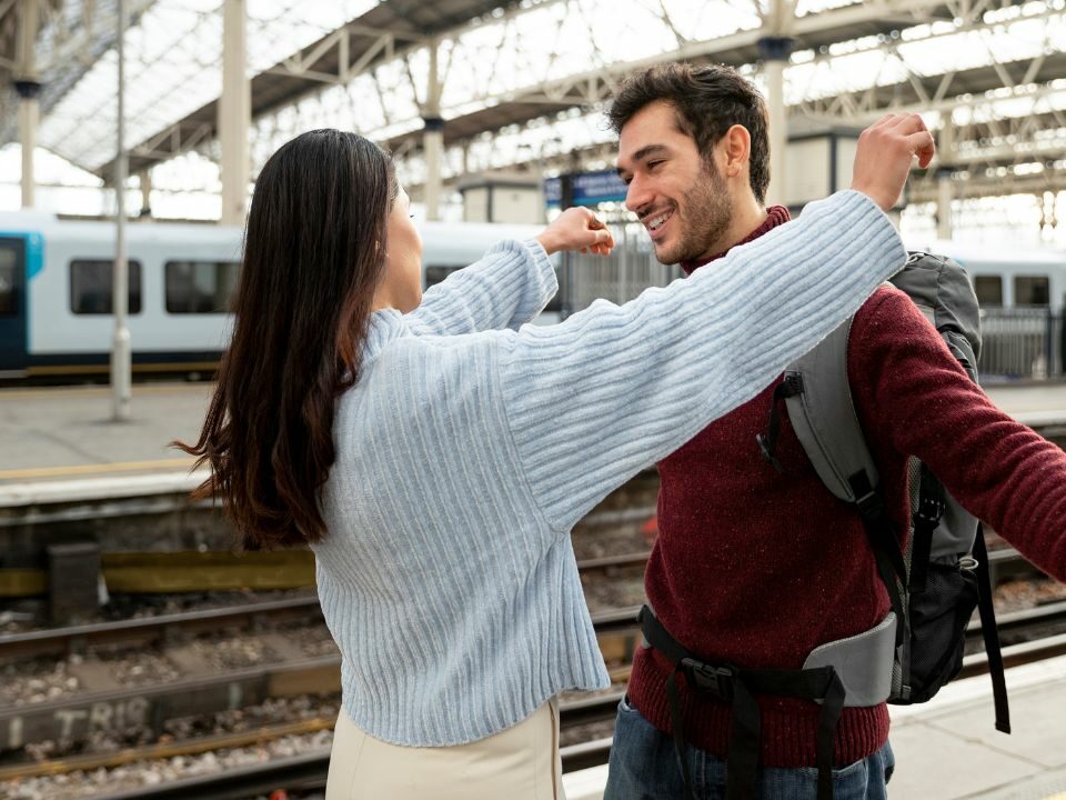 Une femme et un homme qui se rencontre antillaise sur le quai d'une gare